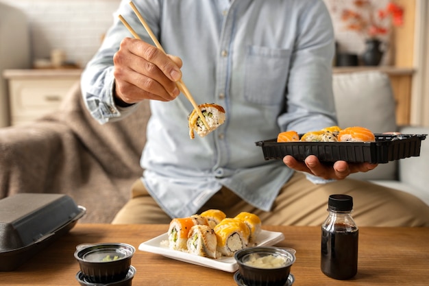 Free photo 17 lifestyle of people ordering sushi at home