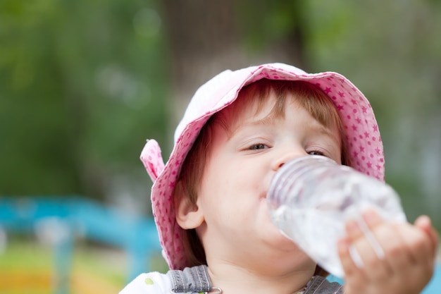 2 years child drinking from  bottle