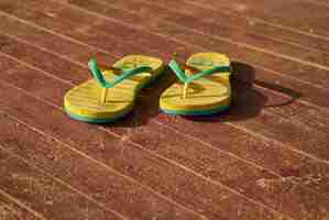 Free photo 2 yellow sandals on wood