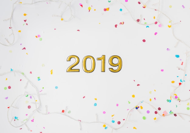 2019 numbers between fairy lights and confetti 