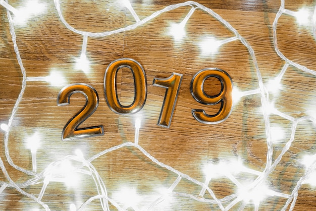 Free photo 2019 numbers between illuminated fairy lights