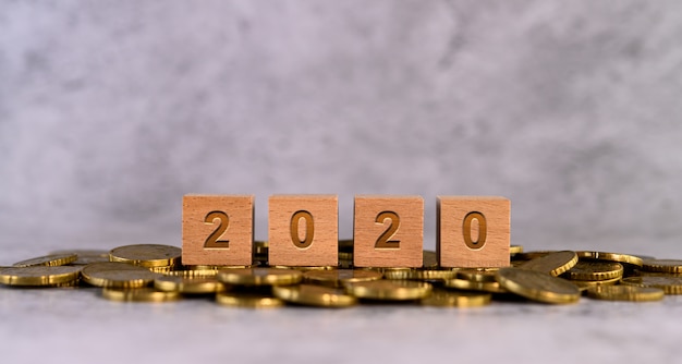 2020 word alphabet wooden cube letters placed on a gold coin