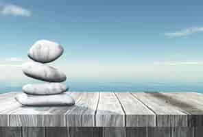 Free photo 3d balancing pebbles on a wooden table looking out to the ocean