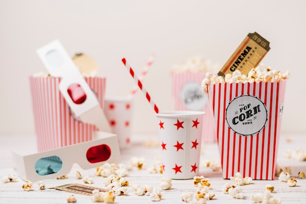 3d glasses; disposable cup with drinking straw; cinema ticket and popcorns