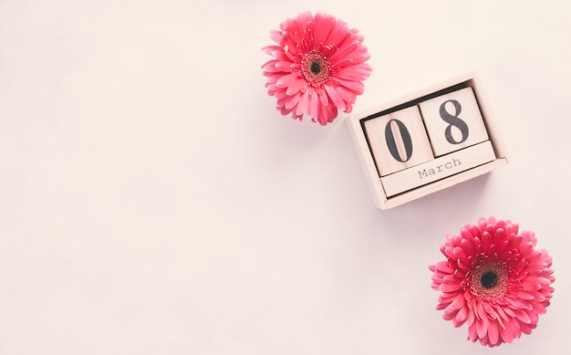 8 March inscription on wooden blocks with flowers