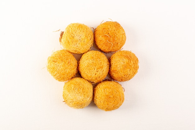 Бесплатное фото Вид спереди круглые вкусные пирожные сладкие вкусные круглые печенья, изолированные на белом