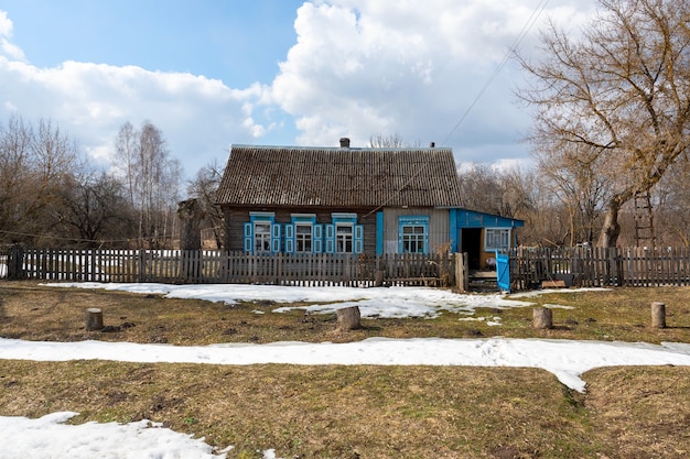 春先​に​窓​に​青い​シャッター​が​付いた​村​の​孤独な​古い​家​。​自然​の​目覚め​。​ロシア​の​奥地
