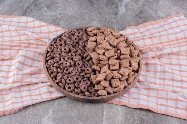 Бесплатное фото Деревянная доска со здоровыми шоколадными зерновыми кольцами и шоколадными подушечками из кукурузных хлопьев.