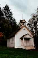 Free photo abandoned closed wooden church in a forest in the countryside