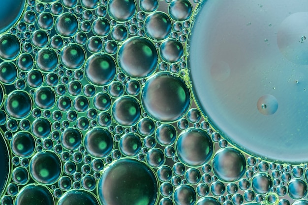 Abstract air bubbles in carbonated water on dark green background