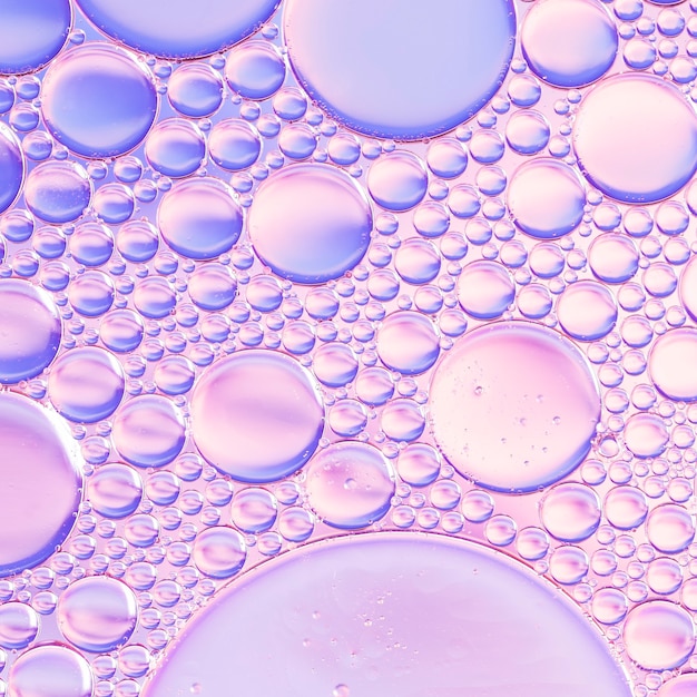 Abstract air bubbles in liquid on pink shaded background