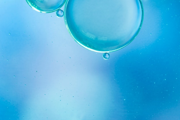 Abstract air bubbles in water on blue blurred background