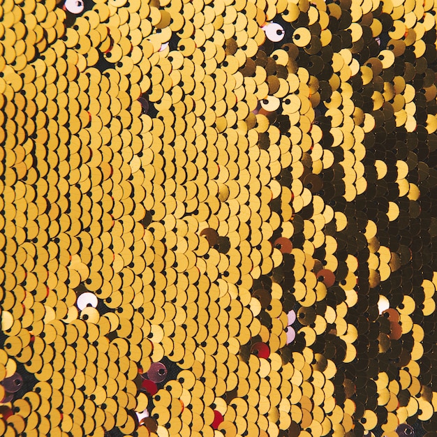 Foto gratuita sfondo astratto con paillettes oro colore sul tessuto