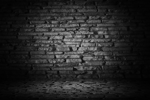 Free photo abstract black cement brick with border black vignette backgroun