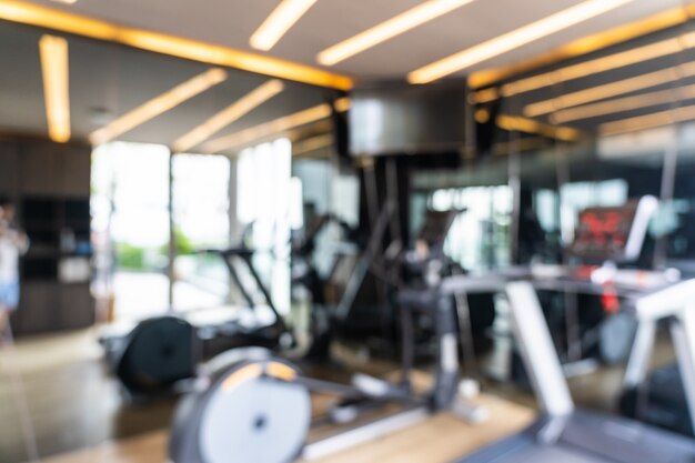 Abstract blur and defocused fitness equipment in gym interior, blurred photo background