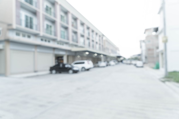 abstract blur image of road with a car and house in the village.