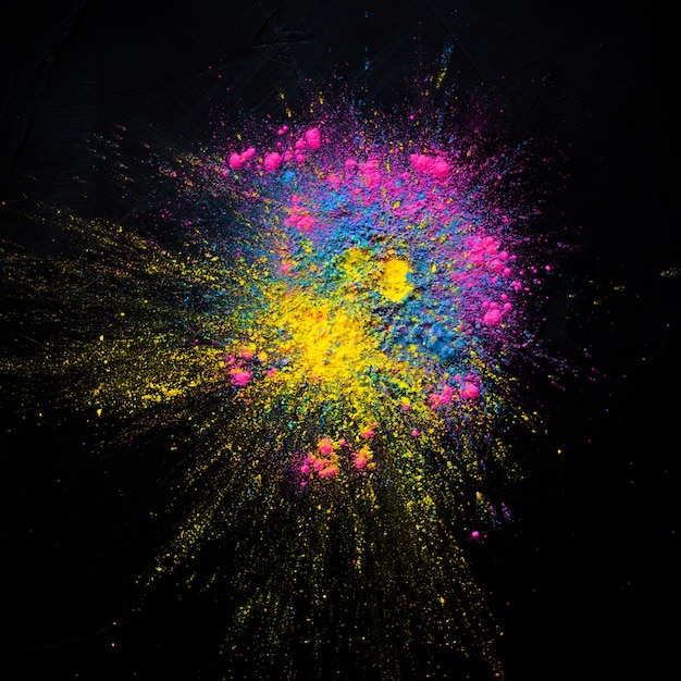 Free photo abstract colored dust explosion on a black background. abstract powder splatted background,