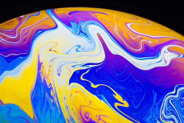 Abstract colorful saturated soap bubble on black background