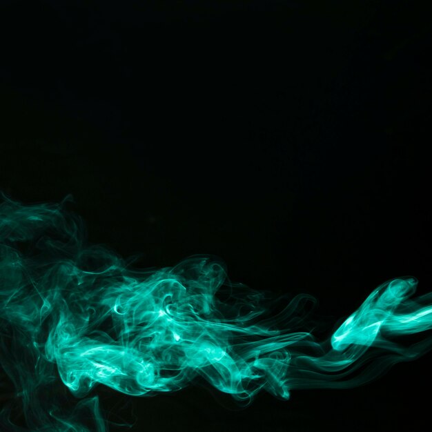 Abstract fragment movement of green smoke on black background