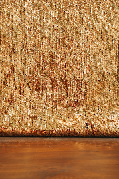 Free photo abstract golden glitter backdrop on wooden desk