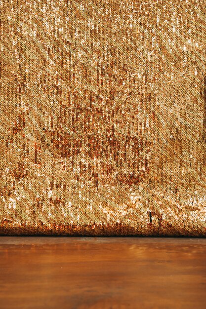 Abstract golden glitter backdrop on wooden desk