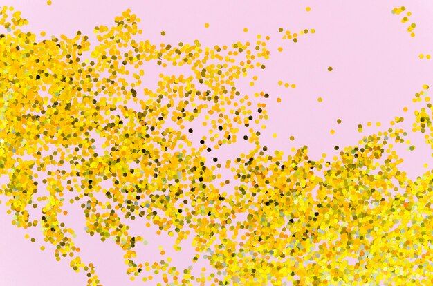 Abstract golden glitter on pink background