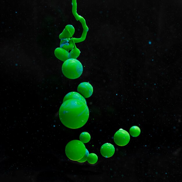 Abstract green acrylic balls on black background