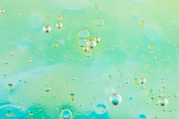 Free photo abstract green background with oil bubbles