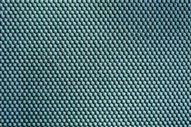 Абстрактный зеленый металлический фон. Текстура точек железа на внешней металлической стене.