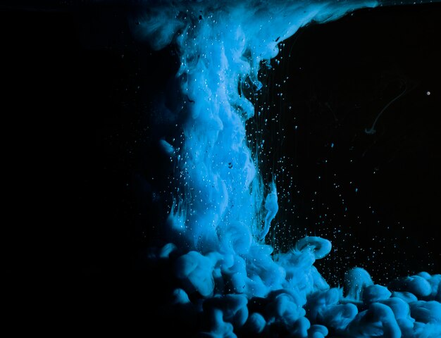 Abstract heavy blue fog in dark liquid