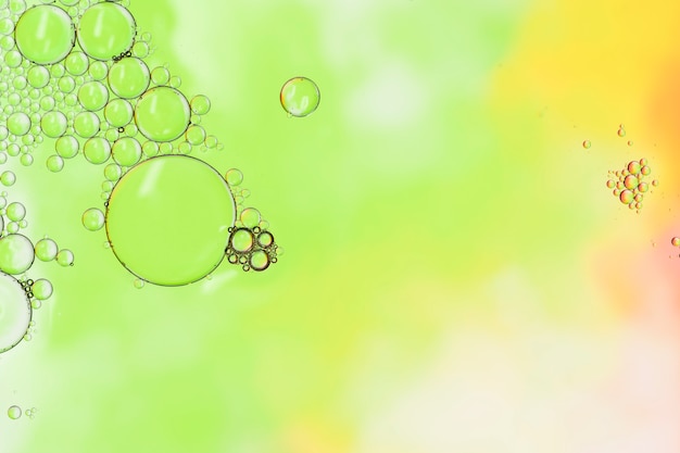 Abstract liquid drops on green background