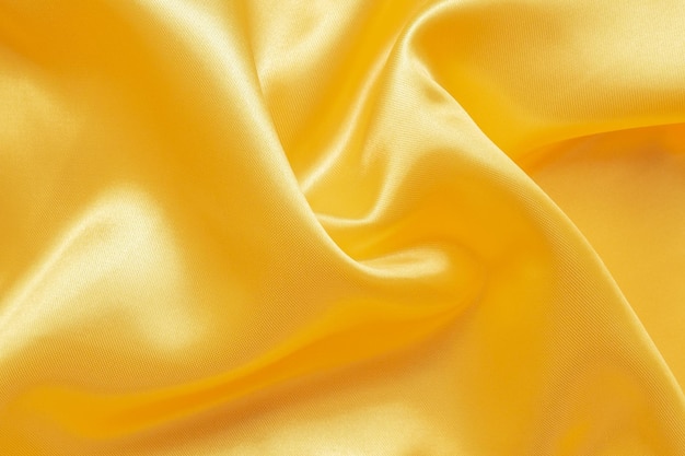 Абстрактная роскошная золотая ткань с мягкой волной текстуры фона