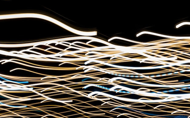 Free photo abstract motion blur messy light trail on black background