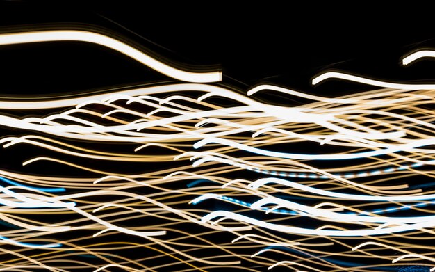 Abstract motion blur messy light trail on black background