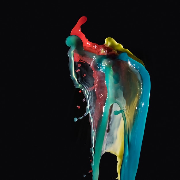 Abstract multicolored water splashing on black backdrop