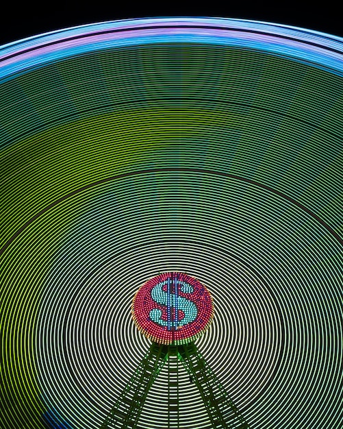 Abstract neon light waves of wonder wheel and dollar sign