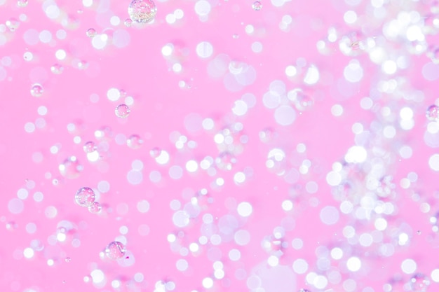 Abstract oil pearls on pink background