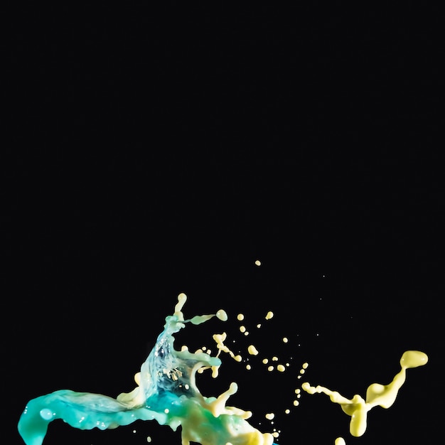 Free photo abstract paint splashing on black backdrop