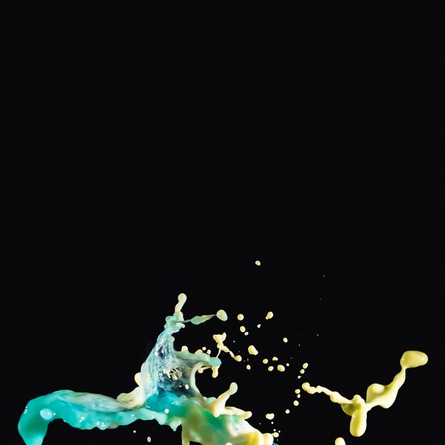 Abstract paint splashing on black backdrop