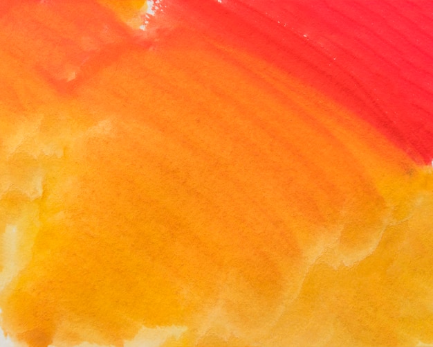 抽象的な塗られた黄色とオレンジ色の水彩画の濡れた背景