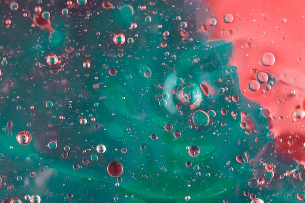 Abstract pattern of colored oil bubbles on water
