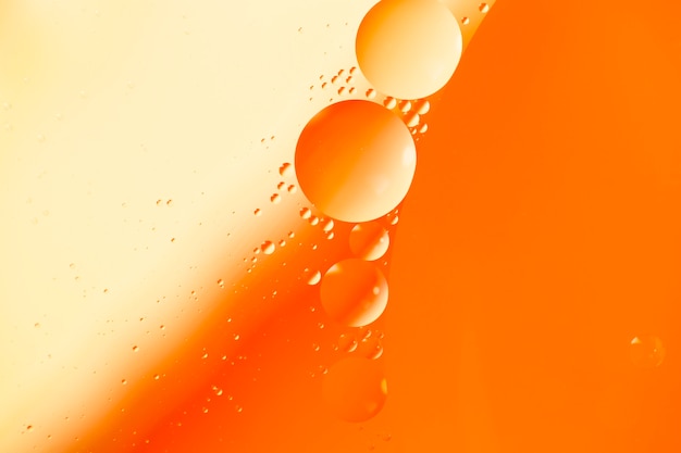 Abstract pattern of coloured oil bubbles on water