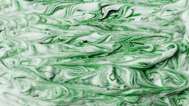 Abstract pattern of green and white paint