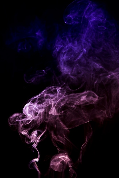 Abstract pink and blue smoke spread on black background