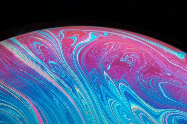 Free photo abstract saturated vivid soap bubble on black background