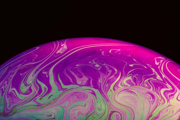 Free photo abstract smooth hued soap bubble on black background