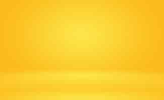 Free photo abstract solid of shining yellow gradient studio wall room background.