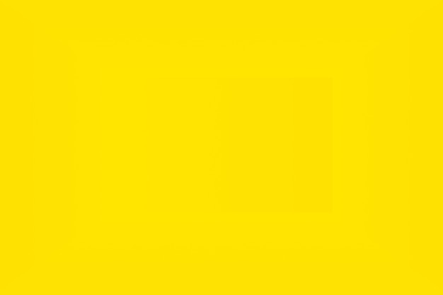 Free photo abstract solid of shining yellow gradient studio wall room background.