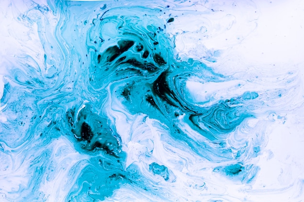 Abstract swirls of blue acrylic paint