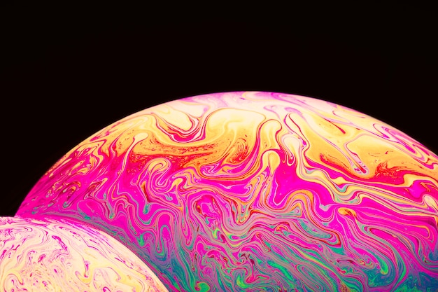 Abstract varicolored psychedelic soap bubbles on black background